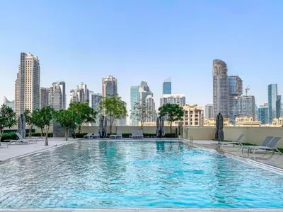 a swimming pool with a city skyline in the background at BURJ ROYALE - Full Burj Khalifa & Fountain Views - LUXE Apartment in Dubai