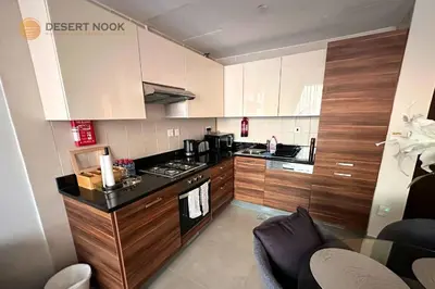 a kitchen with wooden cabinets and a stove top oven at Best Location Marina & Sea View 1 min from JBR in Dubai