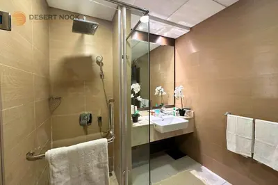 a bathroom with a glass shower and a sink at Best Location Marina & Sea View 1 min from JBR in Dubai