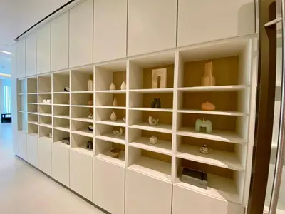 a wall of shelves with vases on them at Grande signature residence Smart Burj khalifa Fountains view large 3 bedroom hall 4 bathroom view burj khalifa Fountains from hall and rooms balcony in Dubai