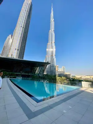a pool in the middle of a city with skyscrapers at Grande signature residence Smart Burj khalifa Fountains view large 3 bedroom hall 4 bathroom view burj khalifa Fountains from hall and rooms balcony in Dubai