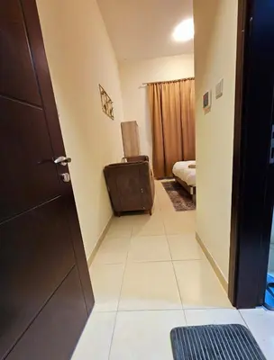 a hallway with a door and a room with a bed at Room with bathroom near beach walk la mer beach Oima leasing property in Dubai