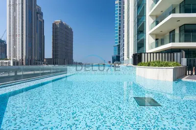 a swimming pool in a city with tall buildings at Exclusive Promo Modern 1BR with Partial Canal Views by Deluxe Holiday Homes in Dubai