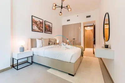 a bedroom with a large bed and a mirror at Exclusive Promo Modern 1BR with Partial Canal Views by Deluxe Holiday Homes in Dubai