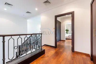 a hallway with a mirror and a stairway at Beach Access Villa with Backyard in Prime Location in Canal Cove, Palm Jumeirah by Deluxe Holiday Homes in Dubai