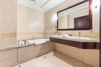 a bathroom with two sinks and a tub and a mirror at Beach Access Villa with Backyard in Prime Location in Canal Cove, Palm Jumeirah by Deluxe Holiday Homes in Dubai