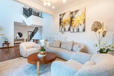 a living room with two couches and a table at Beach Access Villa with Backyard in Prime Location in Canal Cove, Palm Jumeirah by Deluxe Holiday Homes in Dubai