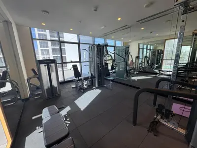 a gym with treadmills and machines in a building at Dubai damac hills luxurious appartment in Dubai