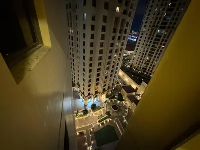 an aerial view of a city at night with tall buildings at Master room in Jumeira Beach Residence - JBR in Dubai