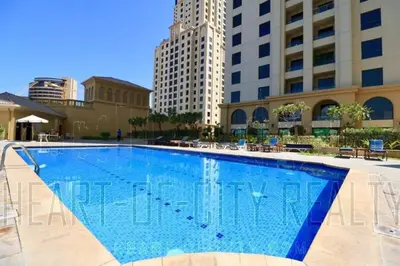 a large swimming pool with buildings in the background at Master room in Jumeira Beach Residence - JBR in Dubai