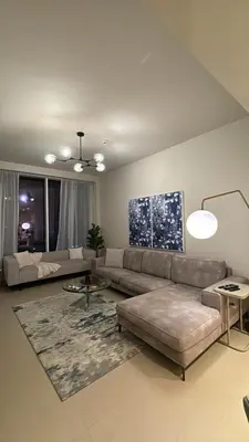 a living room with a couch and a table at 1bedroom Apartment With Stunning view Creek Harbour in Dubai
