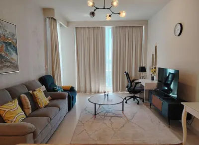 a living room with a couch and a table at Stunning 1BR Apartment High floor Creek Harbour in Dubai
