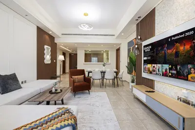 a living room with a couch and a table at Marina Haven I Waterfront I Pool I Gym and Sauna in Dubai