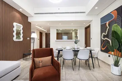 a dining room with a table and chairs at Marina Haven I Waterfront I Pool I Gym and Sauna in Dubai