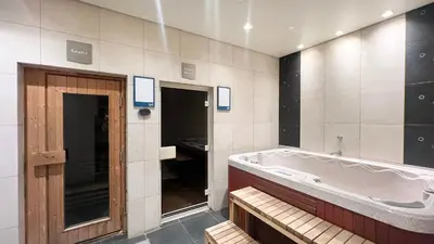 a large bathroom with a tub and a sink at Marina Haven I Waterfront I Pool I Gym and Sauna in Dubai