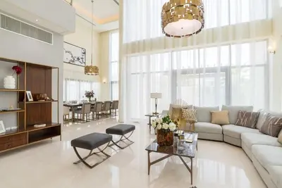 a living room with a couch and a table at Luxurious Meydan Dubai 6 BED Villa Unparalleled Views in Dubai