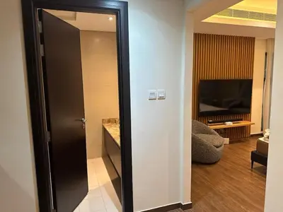 a door leading to a living room with a television at Luxurious Meydan Dubai 6 BED Villa Unparalleled Views in Dubai
