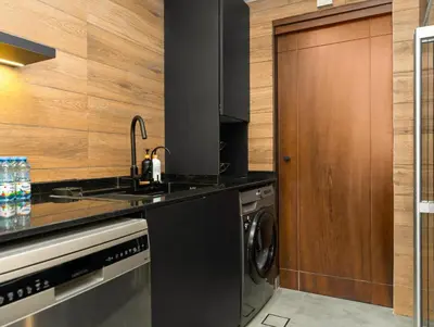 a kitchen with a sink and a washing machine at Luxury 2BR Apartment with Full Marina Views in Dubai