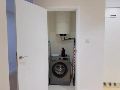 a laundry room with a washer and dryer at Burj KhalifaView Luxury 1-Bedroom Apartment in Dubai