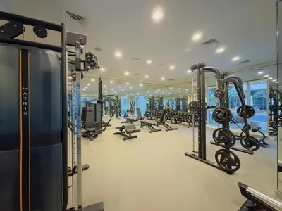 a gym with several rows of treadmills and machines at Burj KhalifaView Luxury 1-Bedroom Apartment in Dubai