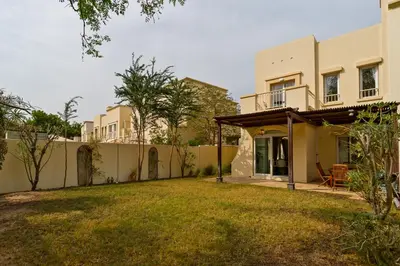 a house with a fence and a yard at Family Friendly - 2BR & Maid's Room in The Springs 10 - Allsopp & Allsopp in Dubai