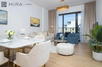 a living room with a white table and chairs at Mira Holiday Homes - Newly 2 bedroom in La Sirene, Port De La Mer in Dubai