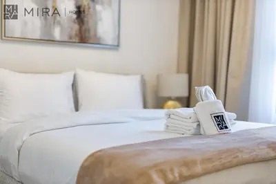 a hotel room with a bed with towels on it at Mira Holiday Homes - Newly 2 bedroom in La Sirene, Port De La Mer in Dubai