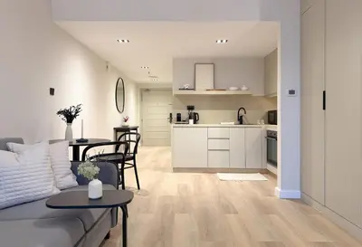a living room and kitchen with a couch and a table at Signature Studio JLT in Dubai