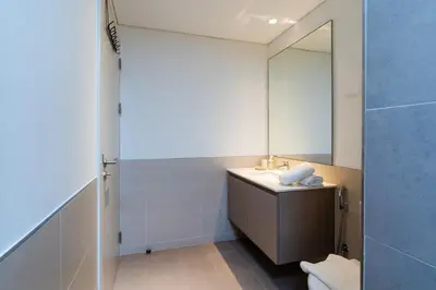a bathroom with a sink and a mirror at Comfortable Stylish Haven - Great Community in Dubai