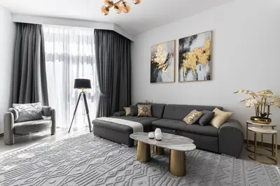 a living room with a couch and a table at SIMPLY COMFORT in Missoni Top Floor with Sea, Canal and Burj Khalifa Views in Dubai