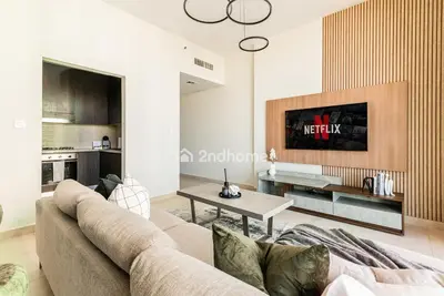 a living room with a couch and a table at Downtown Views 1 A Direct Access to Dubai Mall in Dubai