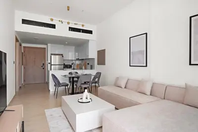 a living room with a couch and a table at Stunning 1 br modern luxury residence at JVC in Dubai