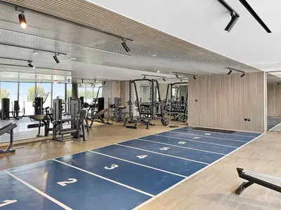 a gym with a bunch of treadmills and machines at Stunning 1 br modern luxury residence at JVC in Dubai