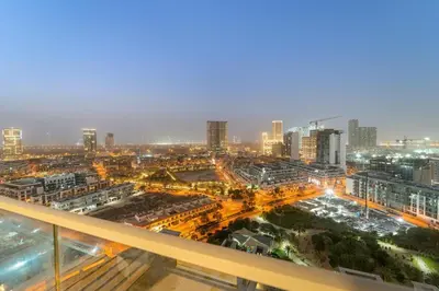 a view of a city at night at Chic JVC Studio in Dubai - Pool, Gym, Free Parking, City Views & Prime Location in Dubai