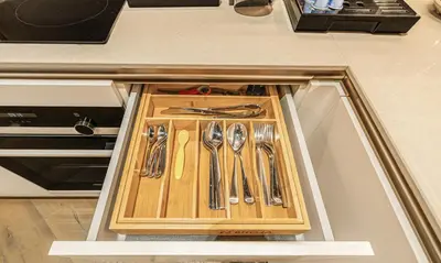 a table with utensils in a drawer in a kitchen at 2BR Jumeirah Gate 1, Marina Skyline View in Dubai
