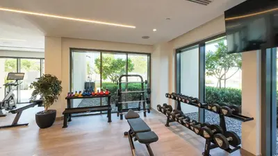 a gym with treadmills and elliptical machines at Prime Downtown Location 2BR Apt Burj Royale in Dubai