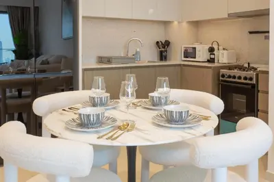a white table with chairs and wine glasses on it at Prime Downtown Location 2BR Apt Burj Royale in Dubai