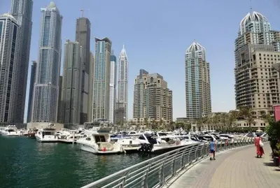 a group of boats docked in a harbor with a city at One bed apartment at a great location in Dubai Marina in Dubai