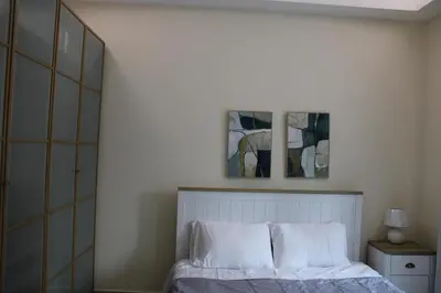 a bedroom with a bed with two pictures on the wall at One bed apartment at a great location in Dubai Marina in Dubai