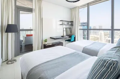 a hotel room with two beds and a window at Frank Porter - 23 Marina in Dubai