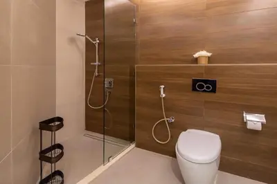 a bathroom with a shower with a toilet and a glass door at Frank Porter - 23 Marina in Dubai