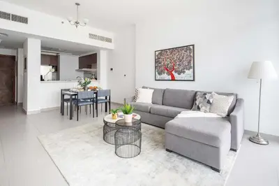 a living room with a couch and a table at Frank Porter - Park Gate in Dubai