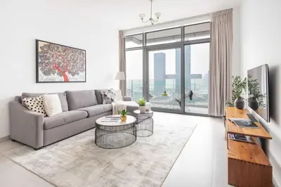 a living room with a couch and a table at Frank Porter - Park Gate in Dubai