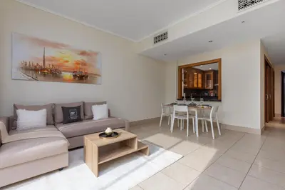 a living room with a couch and a table at Maison Privee - Stylish & Spacious Apartment in Downtown Dubai in Dubai
