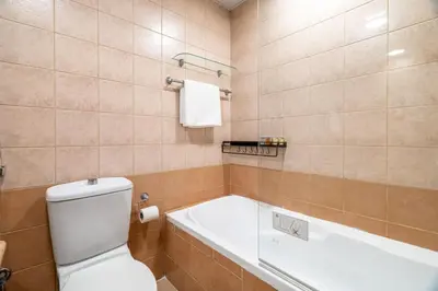 a bathroom with a toilet and a bath tub at GuestReady - Serene Dubai Marina haven in Dubai