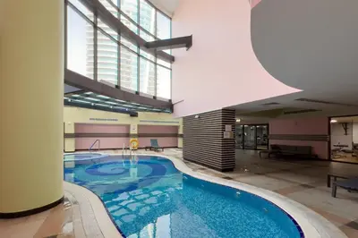 a large swimming pool in a building with a large window at GuestReady - Serene Dubai Marina haven in Dubai