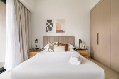 a bedroom with a large white bed and a window at GuestReady - Charming retreat in Downtown Dubai in Dubai