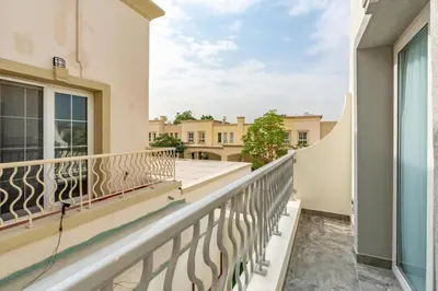 a balcony with a view of a building at White Sage Brand New 3BR Villa with Garden and Two Balconies in Dubai