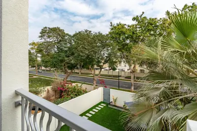 a balcony with a view of a street and trees at White Sage Brand New 3BR Villa with Garden and Two Balconies in Dubai