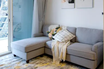 a couch and a chair in a living room at Cozy 1BR Apartment with Water View Business Bay in Dubai
